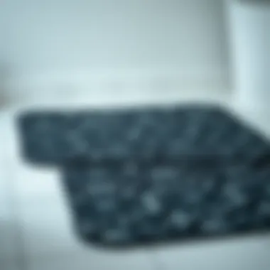 Elegant black patterned bath mat on a tiled floor