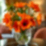 Vibrant orange faux flowers arranged in a stylish vase