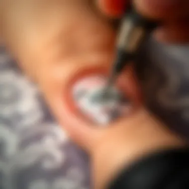 A close-up of a nail being stamped with a floral design