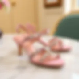 Elegant pink rhinestone sandals displayed on a marble surface